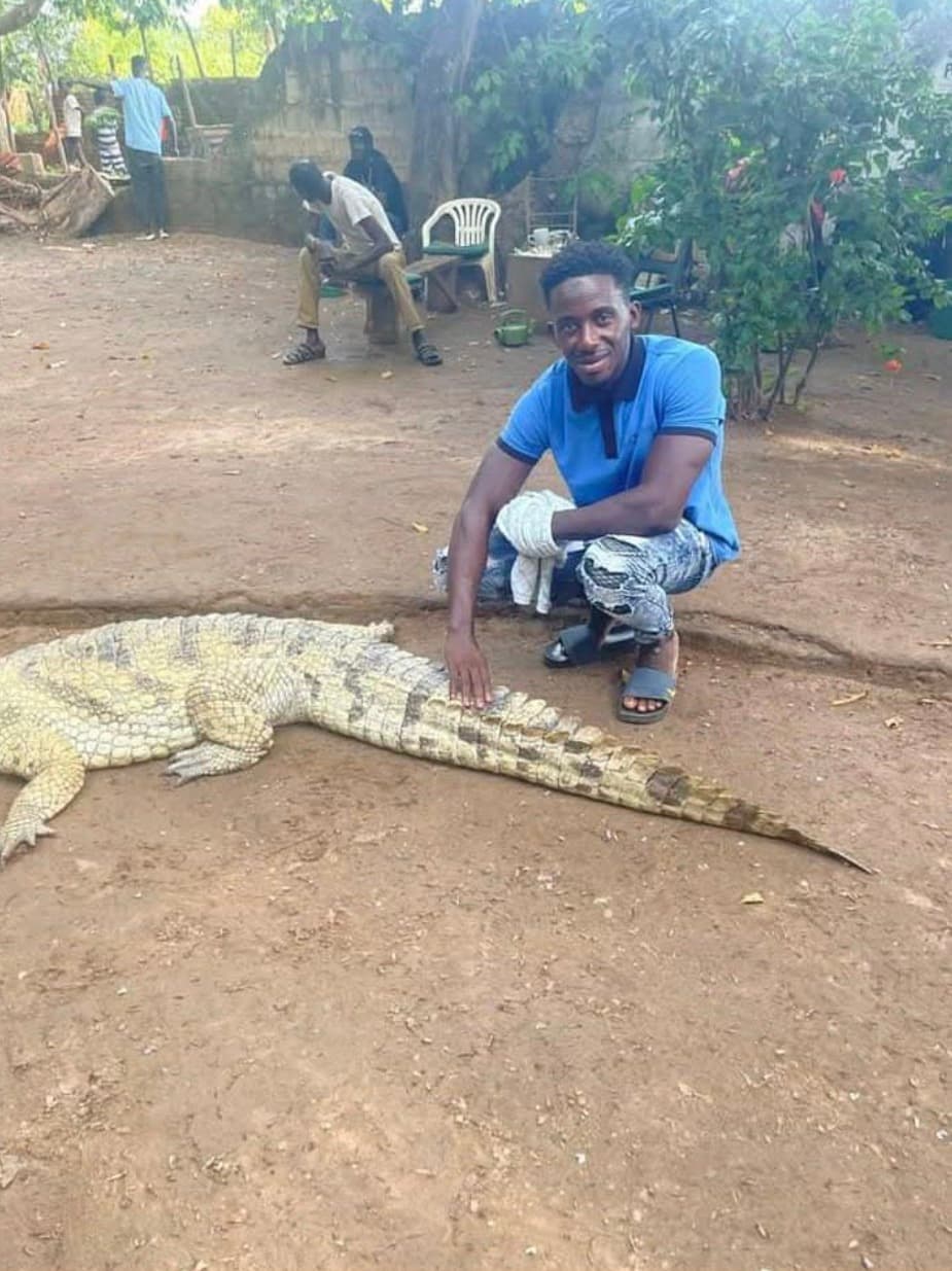 Guests posing confidently near a crocodile experience with their guide.